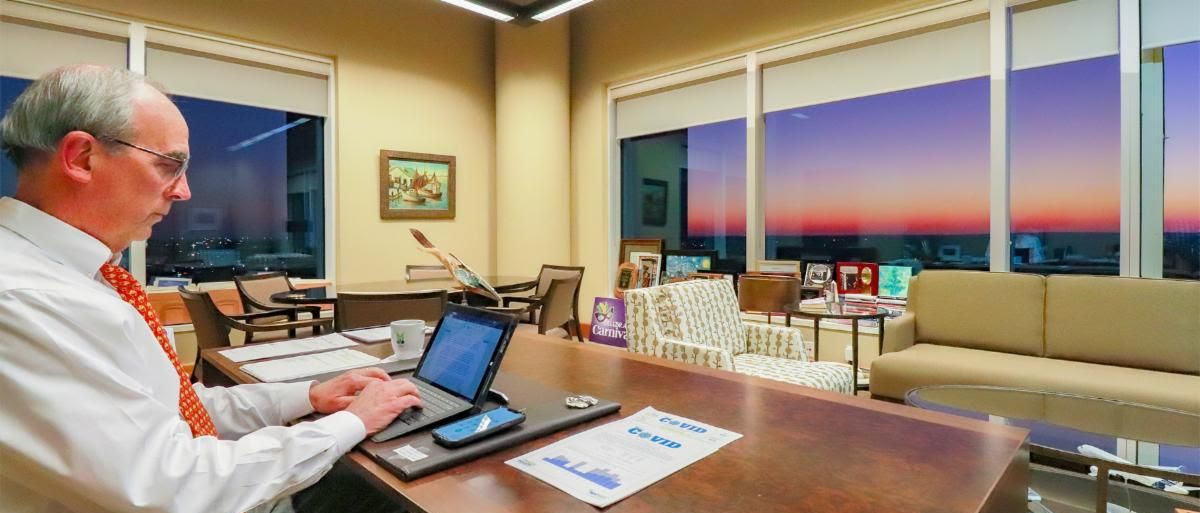Mayor Sandy Stimpson working at his desk in Mobile City Hall, signing off on his nightly newsletter