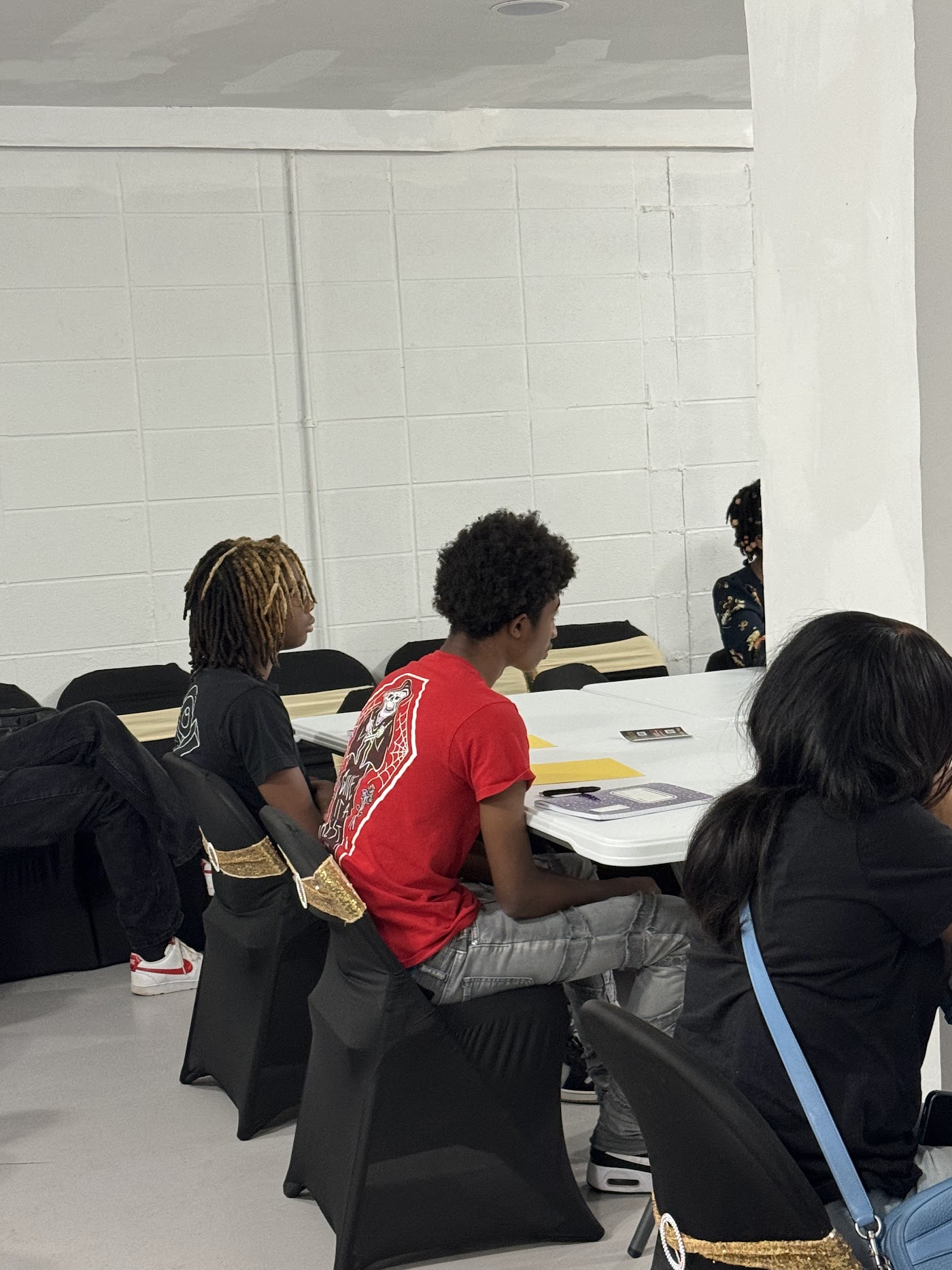 Two teen students seated together, engaged during the STEAM camp session