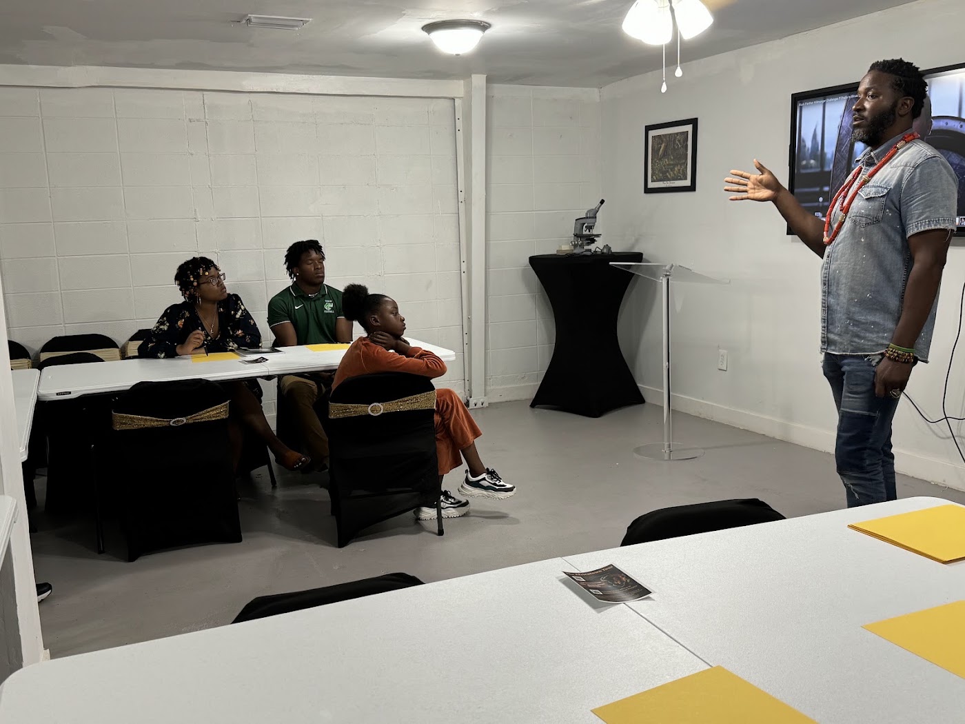 A wide view of the Africatown STEAM camp classroom with students and their mentor