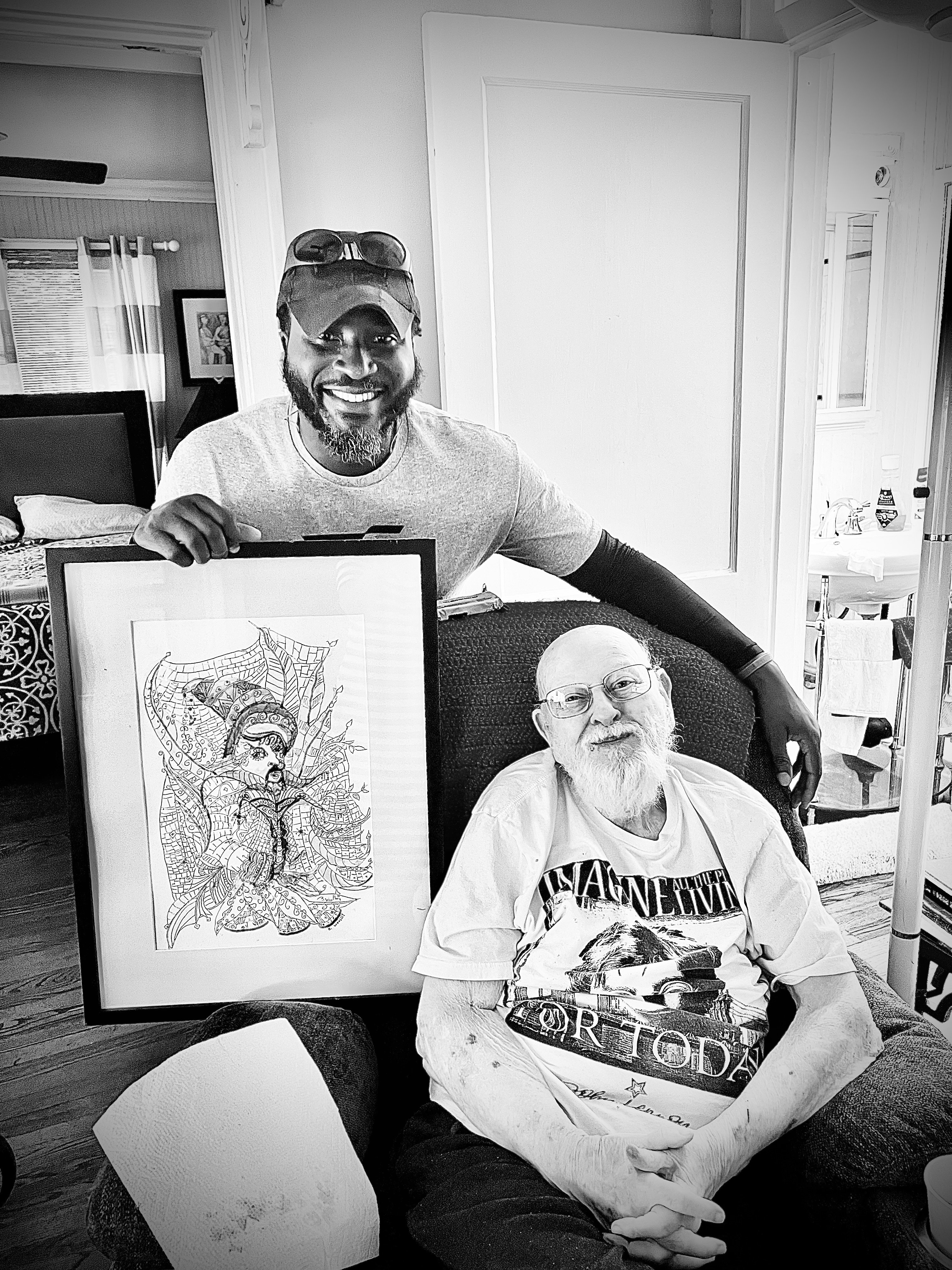 A volunteer presenting a framed ink drawing to an elderly veteran