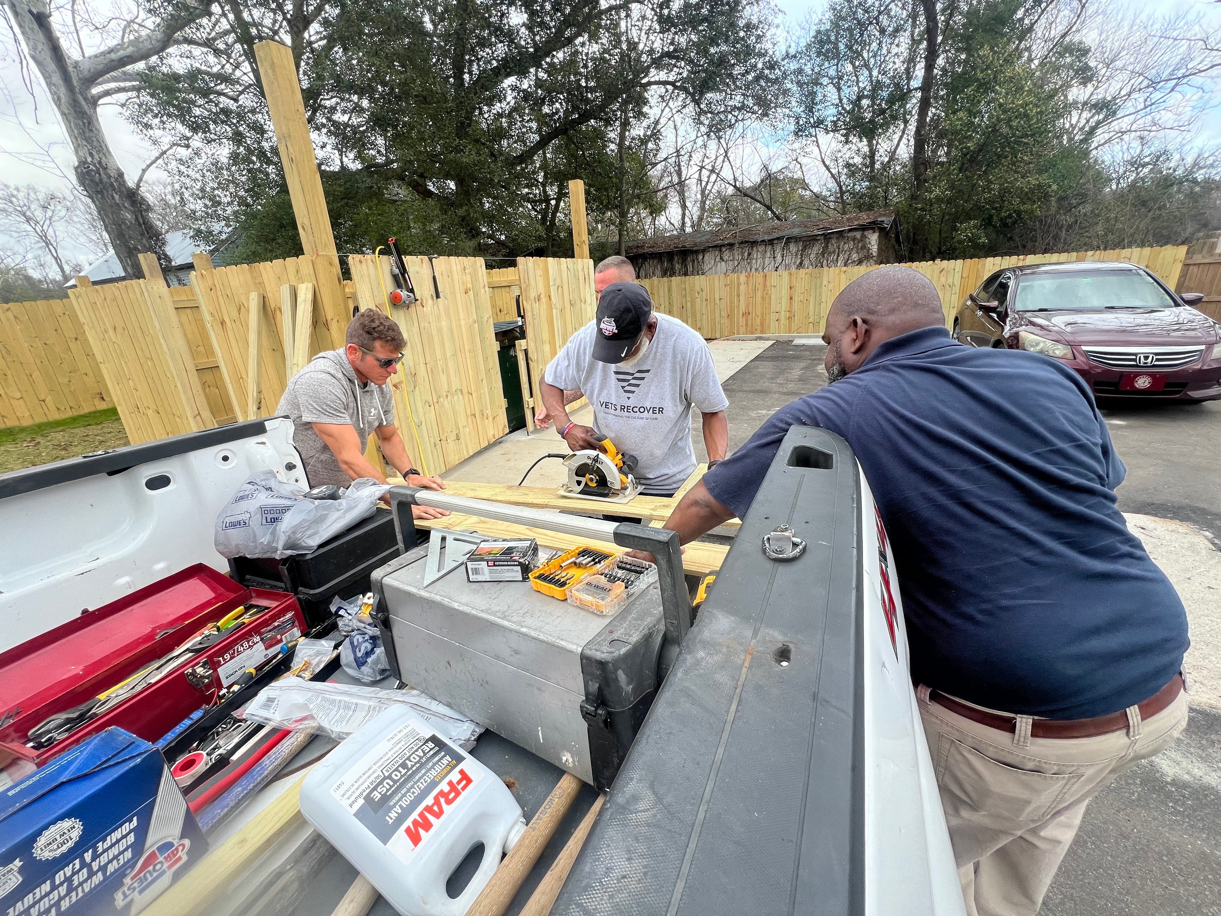 Vets Recover volunteers building a wooden fence together